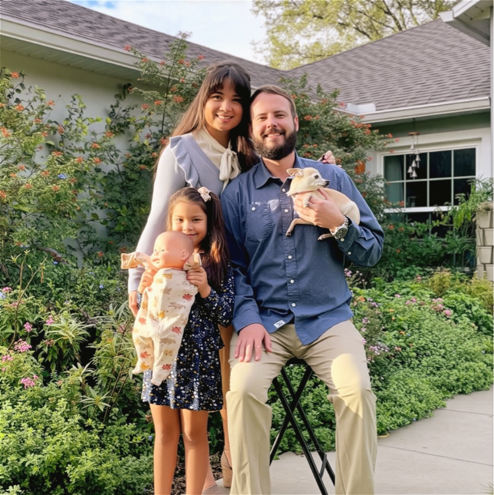 Family of four with two young children and a dog in a garden setting.