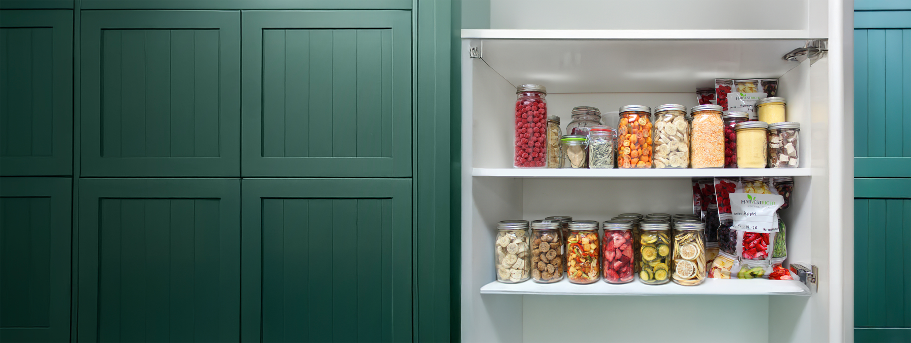 Shelving unit with various food items in jars against a green cabinet background