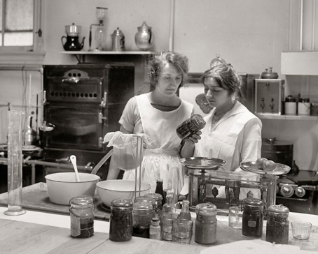 Black and white photo of women canning