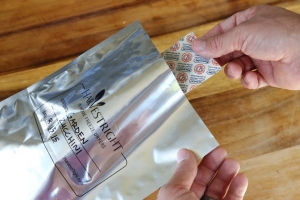 an oxygen absorber being put into a mylar bag