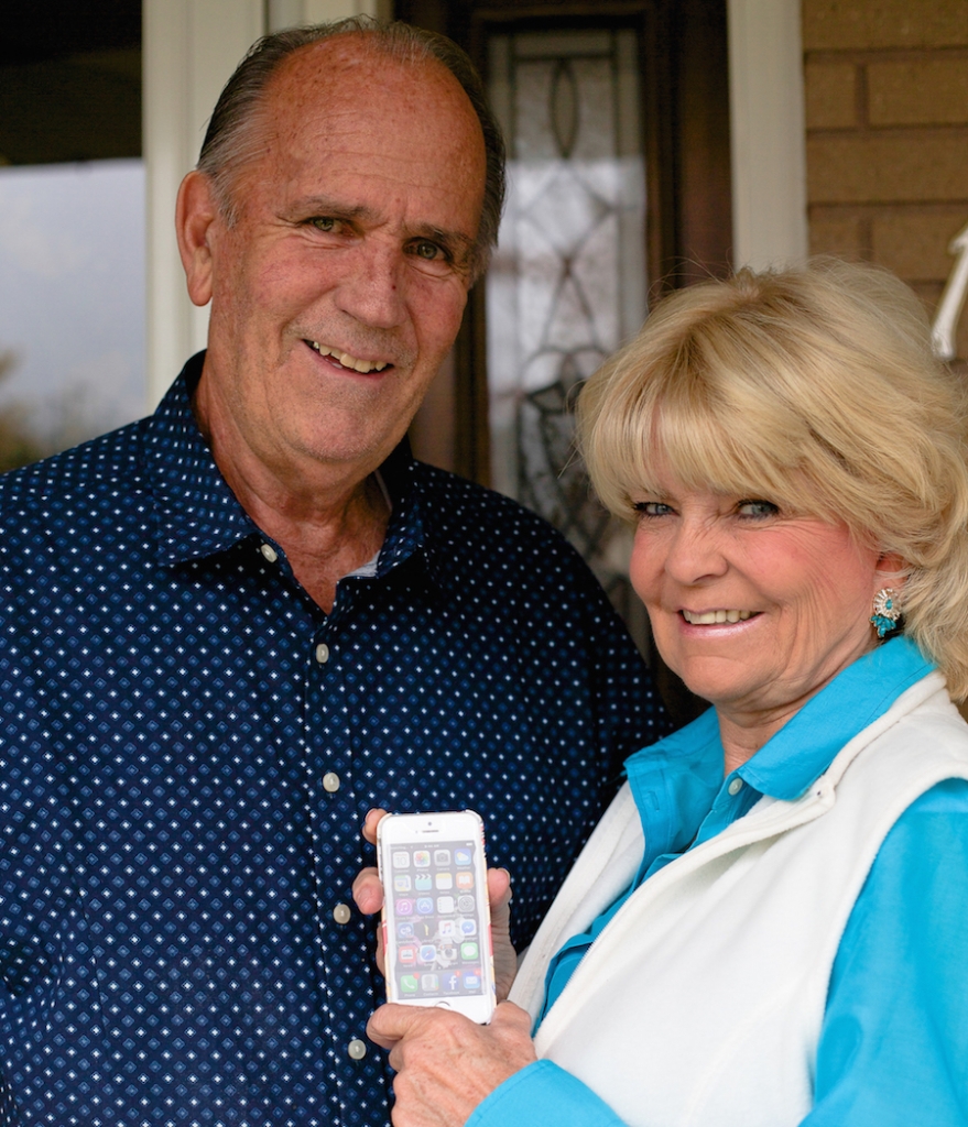 man and woman, woman is holding an iphone