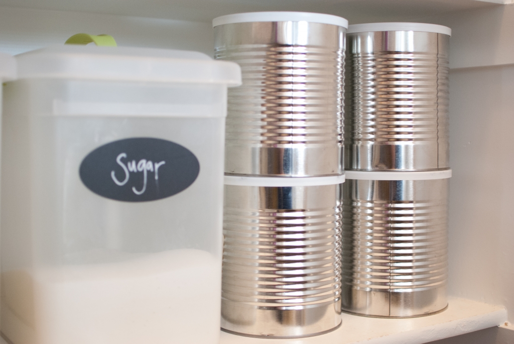 a container of sugar and some cans