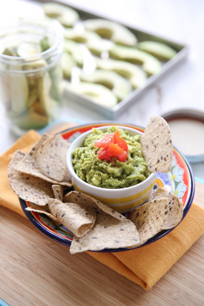 freeze dried avocado slices next to chips and guacamole