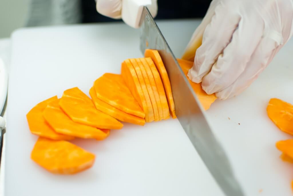 a sweet potato being chipped into chips