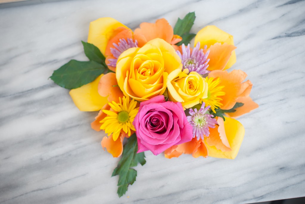 a bouquet of pink, yellow, and orange flowers