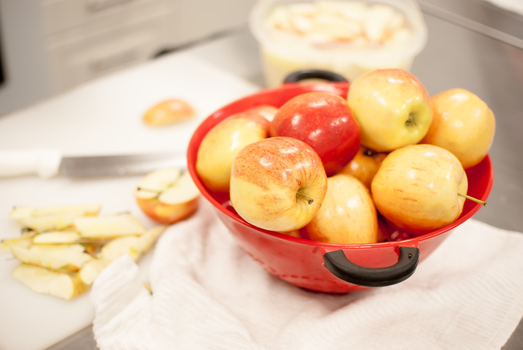 apples in a red bowl