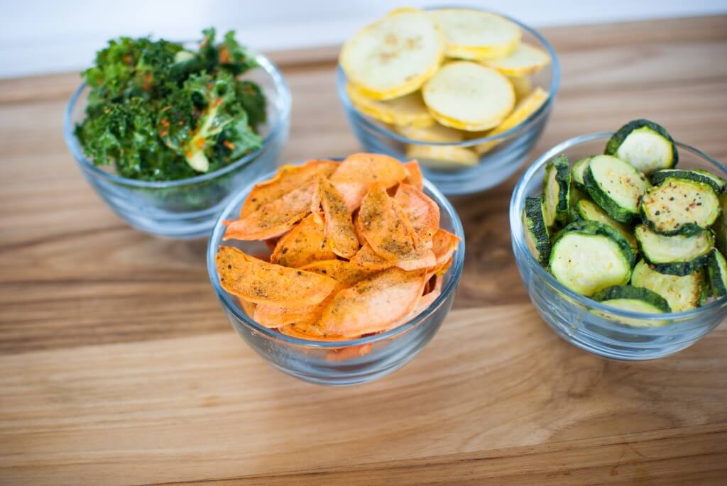 bowls of freeze dried food, sweet potatoes, kale, yellow squash, and zucchini