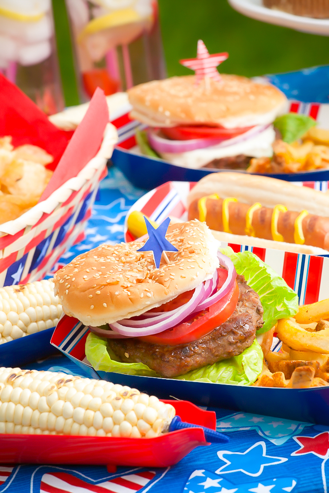 table full of food from a red white and blue cookout