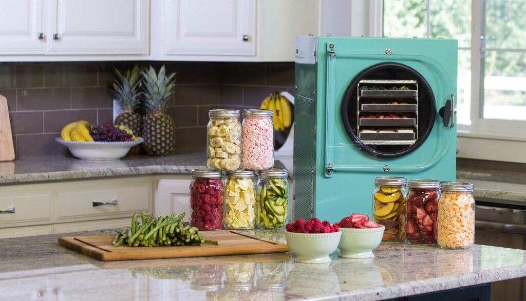 aqua freeze dryer in a kitchen surrounded by freeze dried food