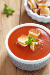 a bowl of tomato soup with Freeze Dried Grilled Cheese Croutons in it