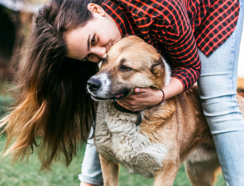 woman hugging a dog