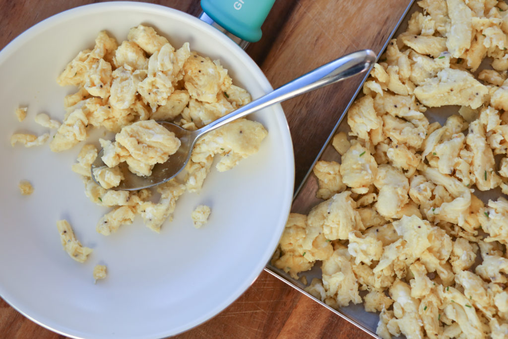 a plate of scrambled eggs and a tray of freeze dried scrambled eggs