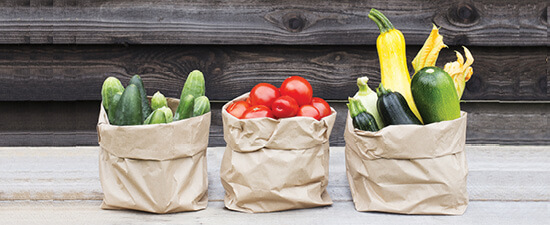 vegetables in brown paper sacks